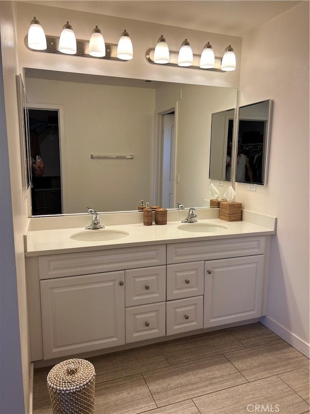 8823 Jacaranda Unit F, Montclair, CA 91763 - bathroom with double vanity, a walk in closet, and wood finished floors