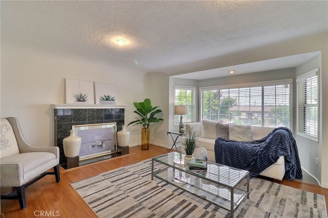 2615 Strathmore Ave, Rosemead, CA 91770 - living room featuring a textured ceiling, baseboards, and wood finished floors