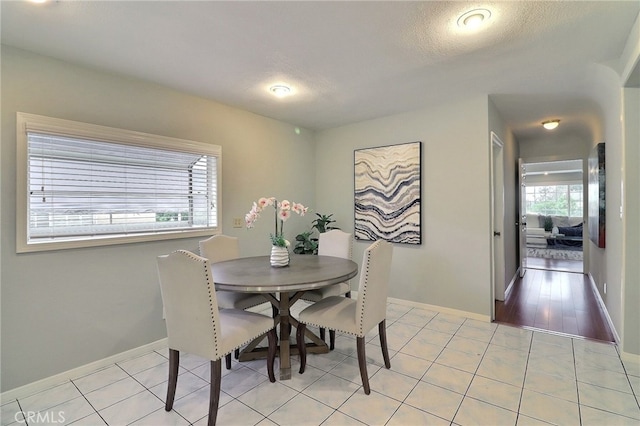 dining area featuring baseboards and light tile patterned floors