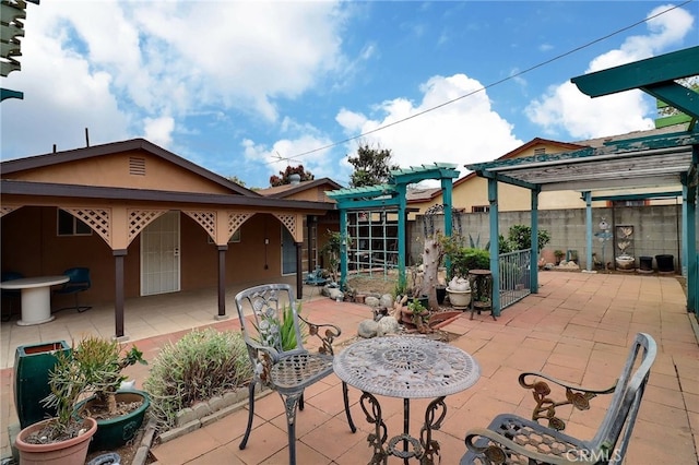 view of patio / terrace featuring a pergola and fence