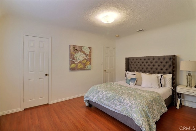 2615 Strathmore Ave, Rosemead, CA 91770 - bedroom featuring wood finished floors, baseboards, and a textured ceiling
