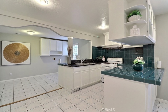 kitchen featuring white cabinets, a sink, tasteful backsplash, open shelves, and white range with gas stovetop