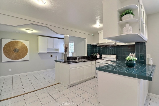 2615 Strathmore Ave, Rosemead, CA 91770 - kitchen with white gas stove, open shelves, a sink, tasteful backsplash, and white cabinetry