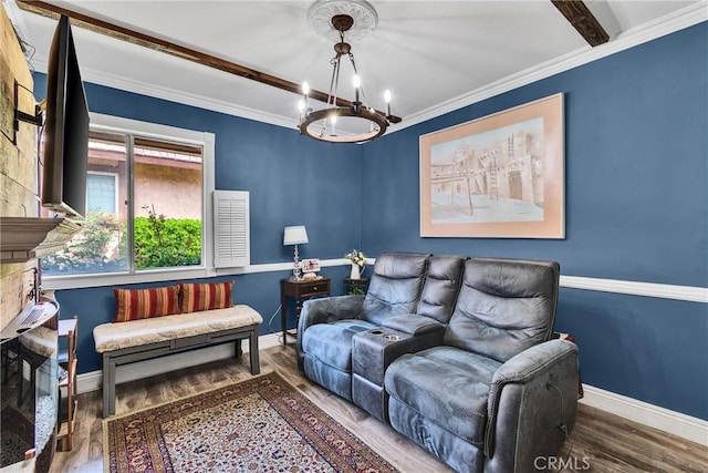 living area with baseboards, wood finished floors, an inviting chandelier, and ornamental molding