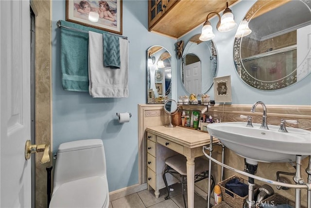 full bath with tile patterned floors, an enclosed shower, a sink, and toilet