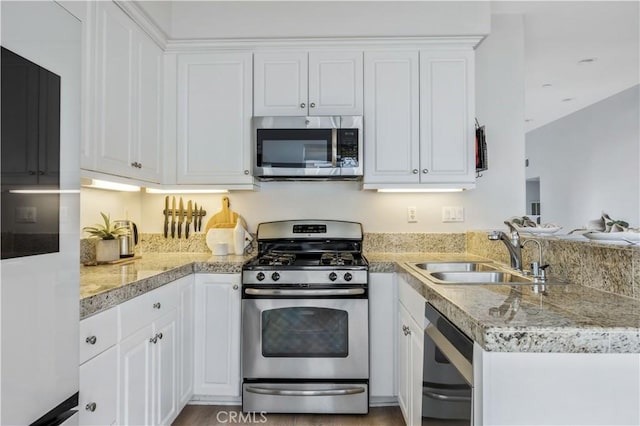 372 W Linden Dr, Orange, CA 92865 - kitchen with stainless steel appliances, a sink, white cabinetry, light countertops, and a peninsula