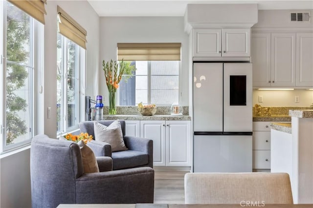 372 W Linden Dr, Orange, CA 92865 - kitchen featuring white refrigerator, white cabinetry, light wood-style flooring, and open floor plan