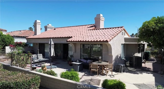 48143 Calle Seranas Ln, Quinta, CA 92253 - back of house with a tiled roof, central AC, a chimney, a patio, and stucco siding