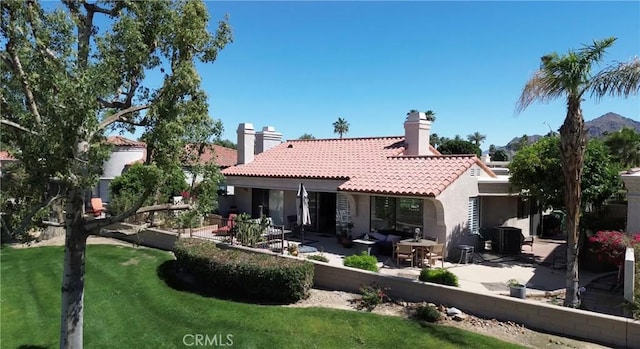 48143 Calle Seranas Ln, Quinta, CA 92253 - back of property featuring a patio, stucco siding, a tiled roof, and a chimney