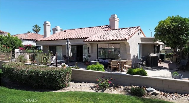 48143 Calle Seranas Ln, Quinta, CA 92253 - back of property featuring a tile roof, a patio, stucco siding, and fence