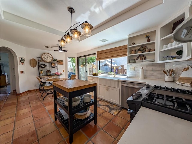 48143 Calle Seranas Ln, Quinta, CA 92253 - kitchen with tile patterned floors, dishwasher, arched walkways, white cabinets, and visible vents