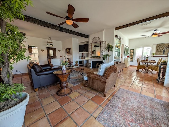48143 Calle Seranas Ln, Quinta, CA 92253 - tiled living area featuring a fireplace, beam ceiling, ceiling fan, and visible vents