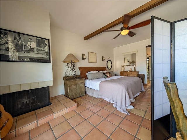 48143 Calle Seranas Ln, Quinta, CA 92253 - tiled bedroom featuring beamed ceiling, a ceiling fan, a fireplace, and multiple windows