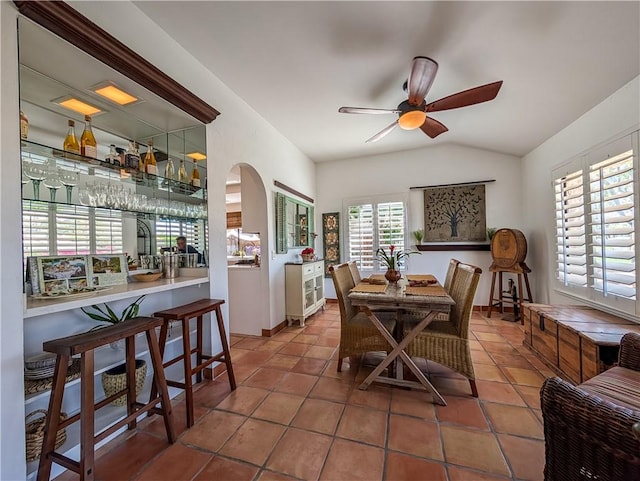 48143 Calle Seranas Ln, Quinta, CA 92253 - dining room with tile patterned floors, a dry bar, vaulted ceiling, baseboards, and ceiling fan