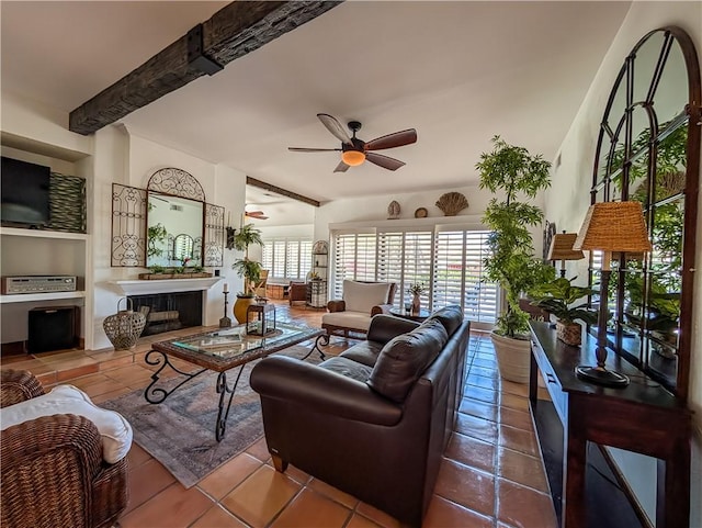 48143 Calle Seranas Ln, Quinta, CA 92253 - tiled living room featuring a ceiling fan, beamed ceiling, and a tiled fireplace