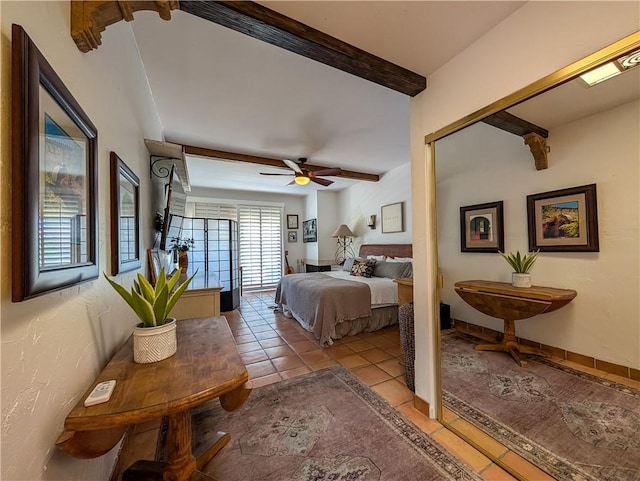 48143 Calle Seranas Ln, Quinta, CA 92253 - bedroom with beamed ceiling, ceiling fan, and light tile patterned flooring