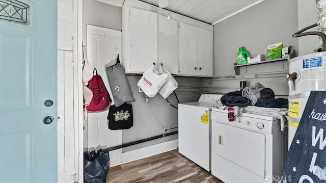 laundry room with water heater, wood finished floors, washer and dryer, and cabinet space