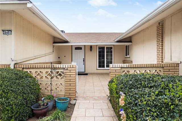 26481 Jamestown Dr, Menifee, CA 92586 - view of exterior entry featuring roof with shingles