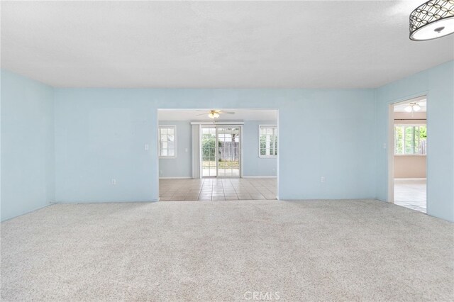 26481 Jamestown Dr, Menifee, CA 92586 - carpeted empty room featuring ceiling fan and tile patterned flooring