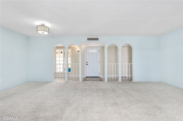 26481 Jamestown Dr, Menifee, CA 92586 - carpeted empty room featuring arched walkways