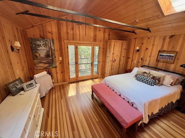 15 Toyon Trl, Berry Creek, CA 95916 - bedroom with vaulted ceiling, wood ceiling, access to outside, wooden walls, and wood finished floors