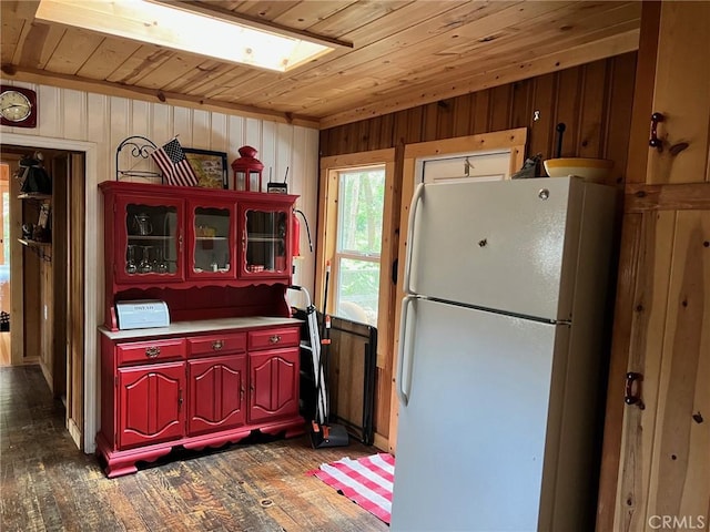 15 Toyon Trl, Berry Creek, CA 95916 - kitchen with freestanding refrigerator, wooden ceiling, wood walls, dark wood-style flooring, and light countertops