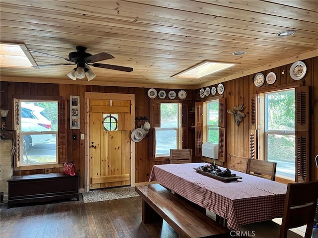 15 Toyon Trl, Berry Creek, CA 95916 - dining room with a skylight, wooden walls, ceiling fan, wooden ceiling, and dark wood-type flooring