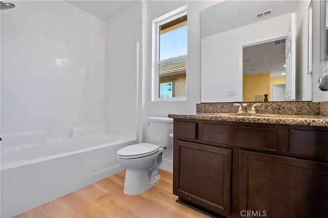 full bathroom with toilet, vanity, wood finished floors, and visible vents