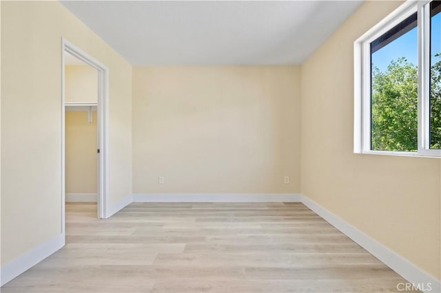 unfurnished bedroom with light wood-type flooring and baseboards