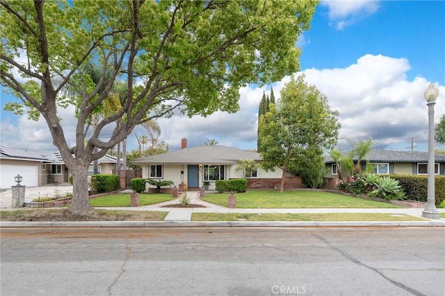 single story home with a front lawn and a chimney