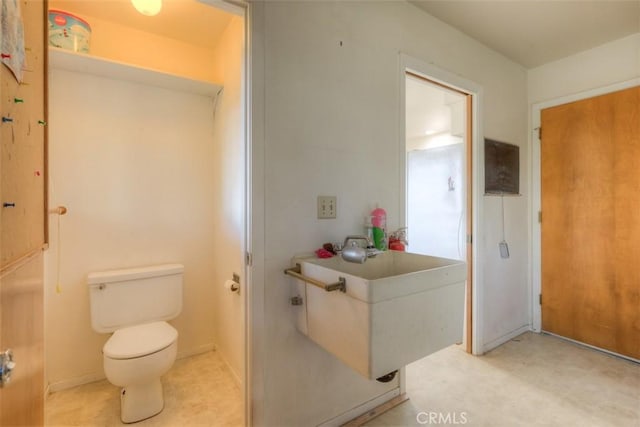 bathroom featuring tile patterned floors, a sink, and toilet