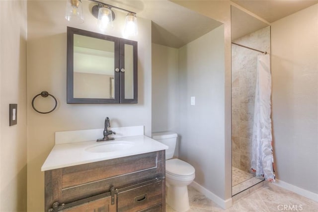 full bathroom with baseboards, vanity, toilet, and tiled shower