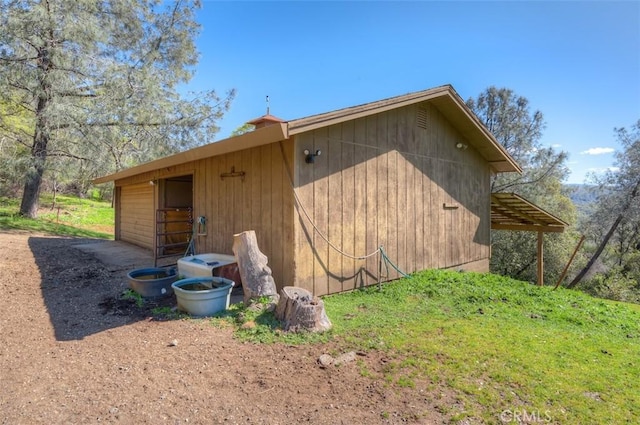view of side of home featuring an exterior structure and an outbuilding