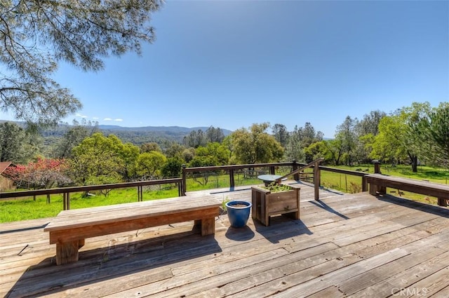 wooden terrace featuring a forest view