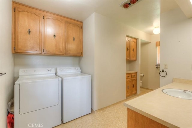 laundry room with washer and dryer, a sink, and laundry area