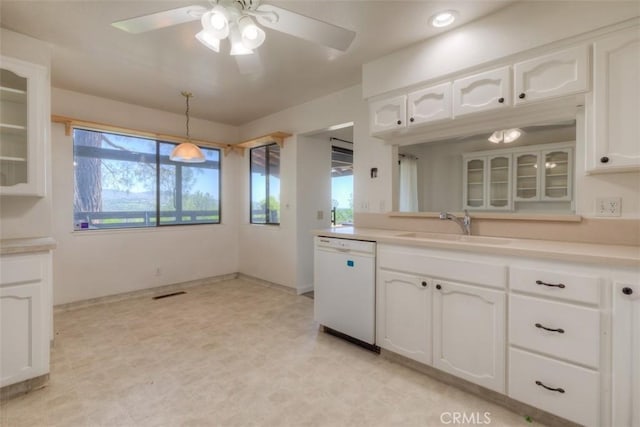 kitchen with a sink, glass insert cabinets, dishwasher, ceiling fan, and white cabinets