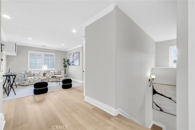hall featuring recessed lighting, wood finished floors, baseboards, and ornamental molding