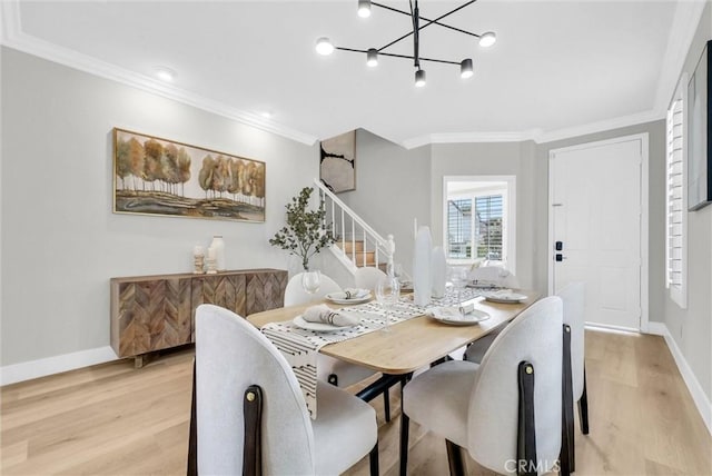 dining room featuring stairs, an inviting chandelier, light wood-style flooring, baseboards, and ornamental molding