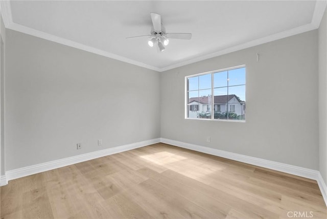 unfurnished room featuring ceiling fan, baseboards, crown molding, and light wood-style floors