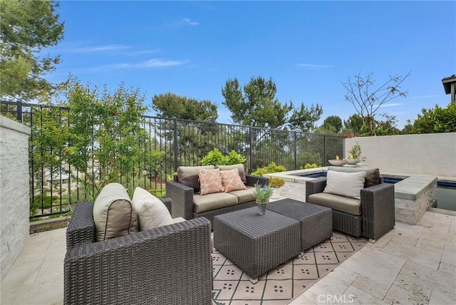 view of patio / terrace with an outdoor hangout area, fence, and a jacuzzi