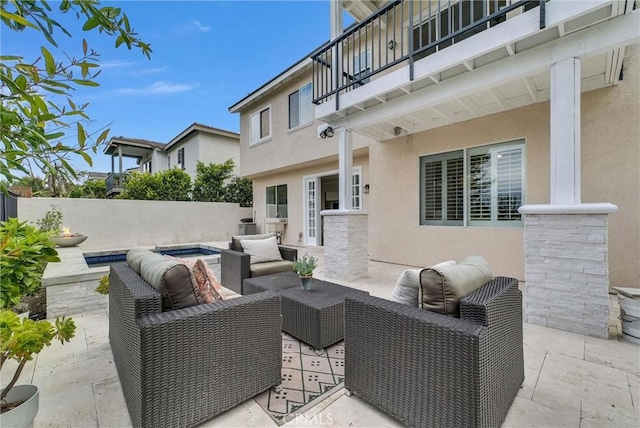 view of patio featuring fence, an outdoor living space, and a balcony