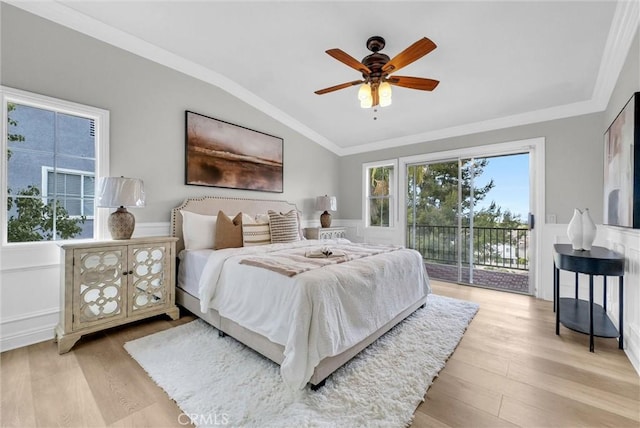 bedroom with vaulted ceiling, multiple windows, access to exterior, and light wood-type flooring