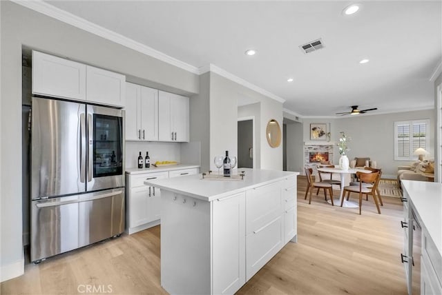kitchen with smart refrigerator, a ceiling fan, light wood-style floors, light countertops, and ornamental molding