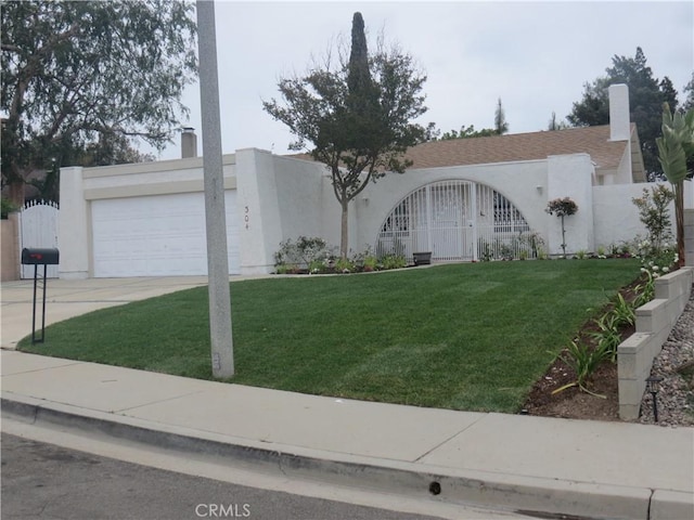 view of front facade featuring an attached garage, a chimney, concrete driveway, and stucco siding