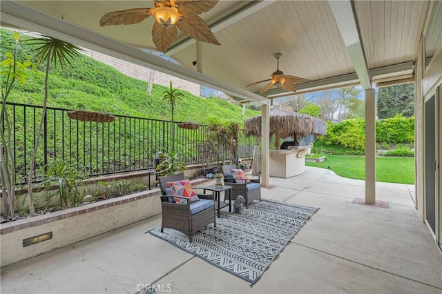 view of patio / terrace featuring outdoor lounge area, ceiling fan, and fence