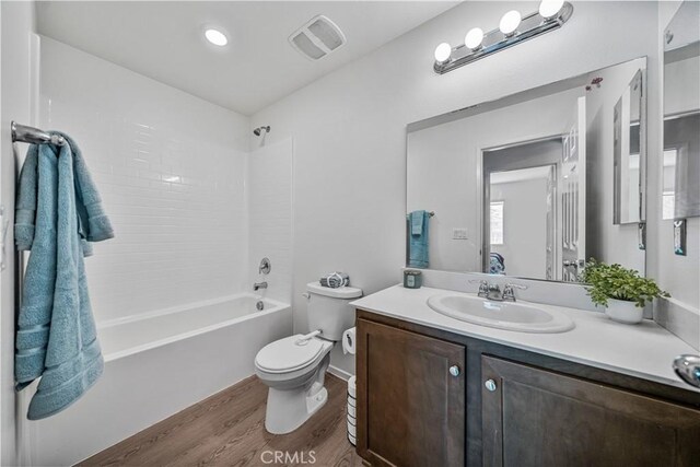 67410 Rio Vista Dr, Cathedral City, CA 92234 - bathroom with wood finished floors, toilet, vanity, and  shower combination