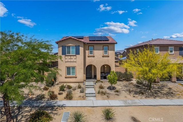 67410 Rio Vista Dr, Cathedral City, CA 92234 - view of front of property with roof mounted solar panels, stucco siding, a tiled roof, fence, and a porch