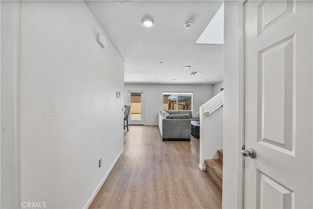 67410 Rio Vista Dr, Cathedral City, CA 92234 - hallway with light wood-style floors, baseboards, and stairs