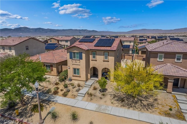 67410 Rio Vista Dr, Cathedral City, CA 92234 - mediterranean / spanish-style house featuring a residential view, a mountain view, solar panels, stucco siding, and a tile roof