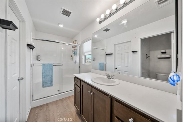 67410 Rio Vista Dr, Cathedral City, CA 92234 - full bath featuring a stall shower, wood finished floors, vanity, and toilet